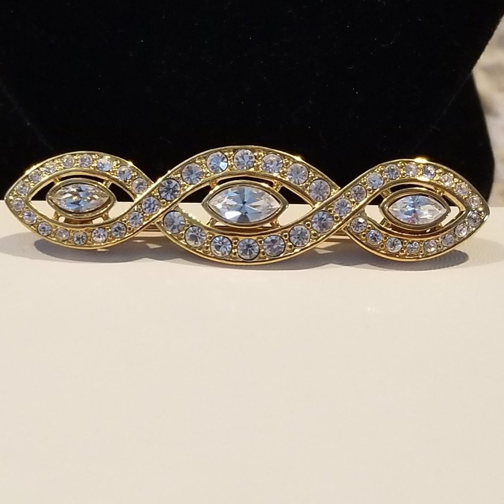 Vintage Signed Trifari gold toned and rhinestone brooch.